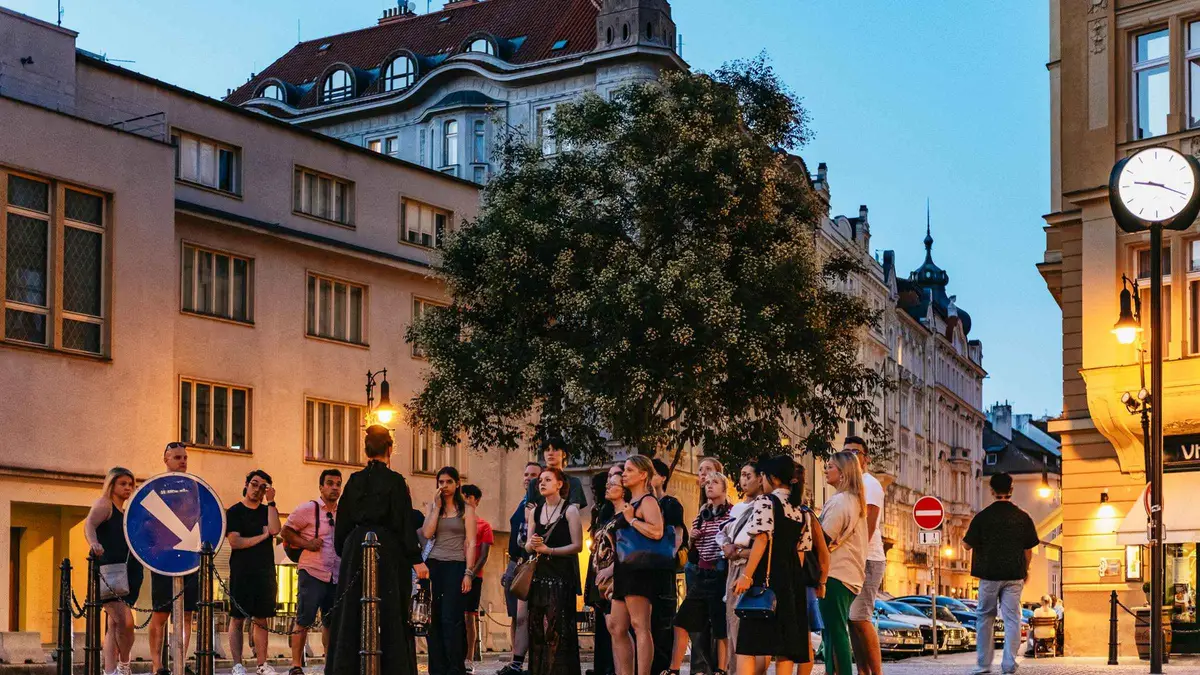 Costumed storyteller guide on a ghost tour in the Old Town of Prague at night, Czechia